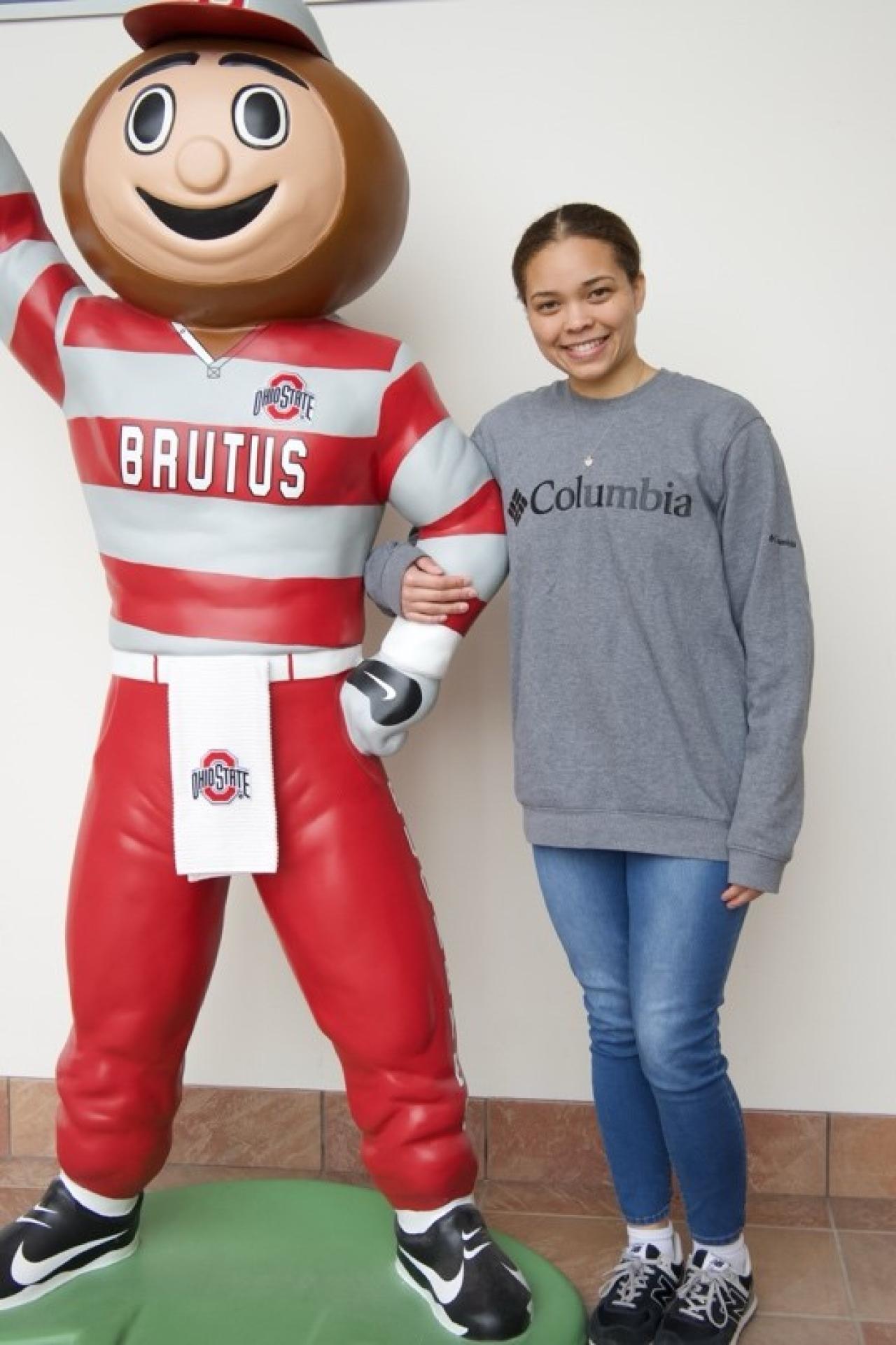 Destiny Moton posing with a statue of Brutus Buckeye