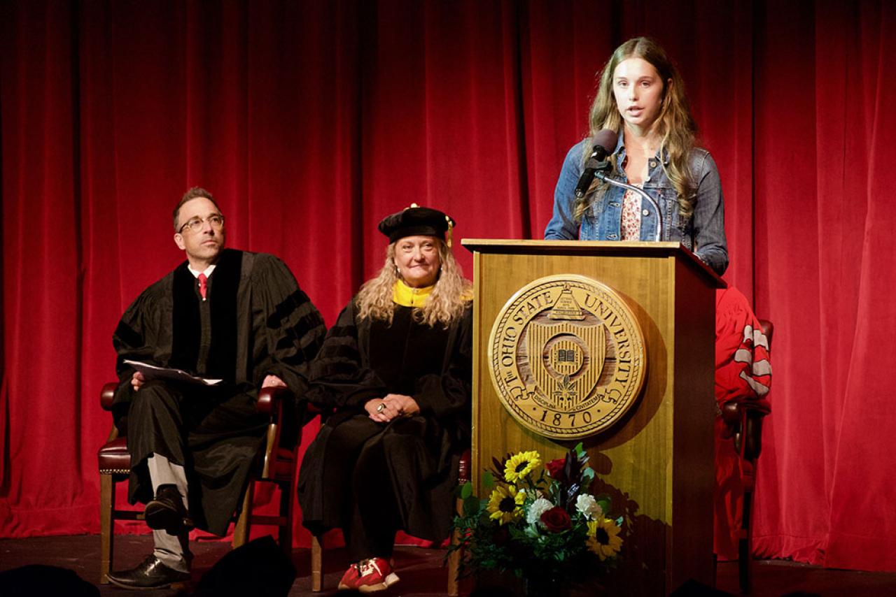 a female, makena, speaking on stage at convocation