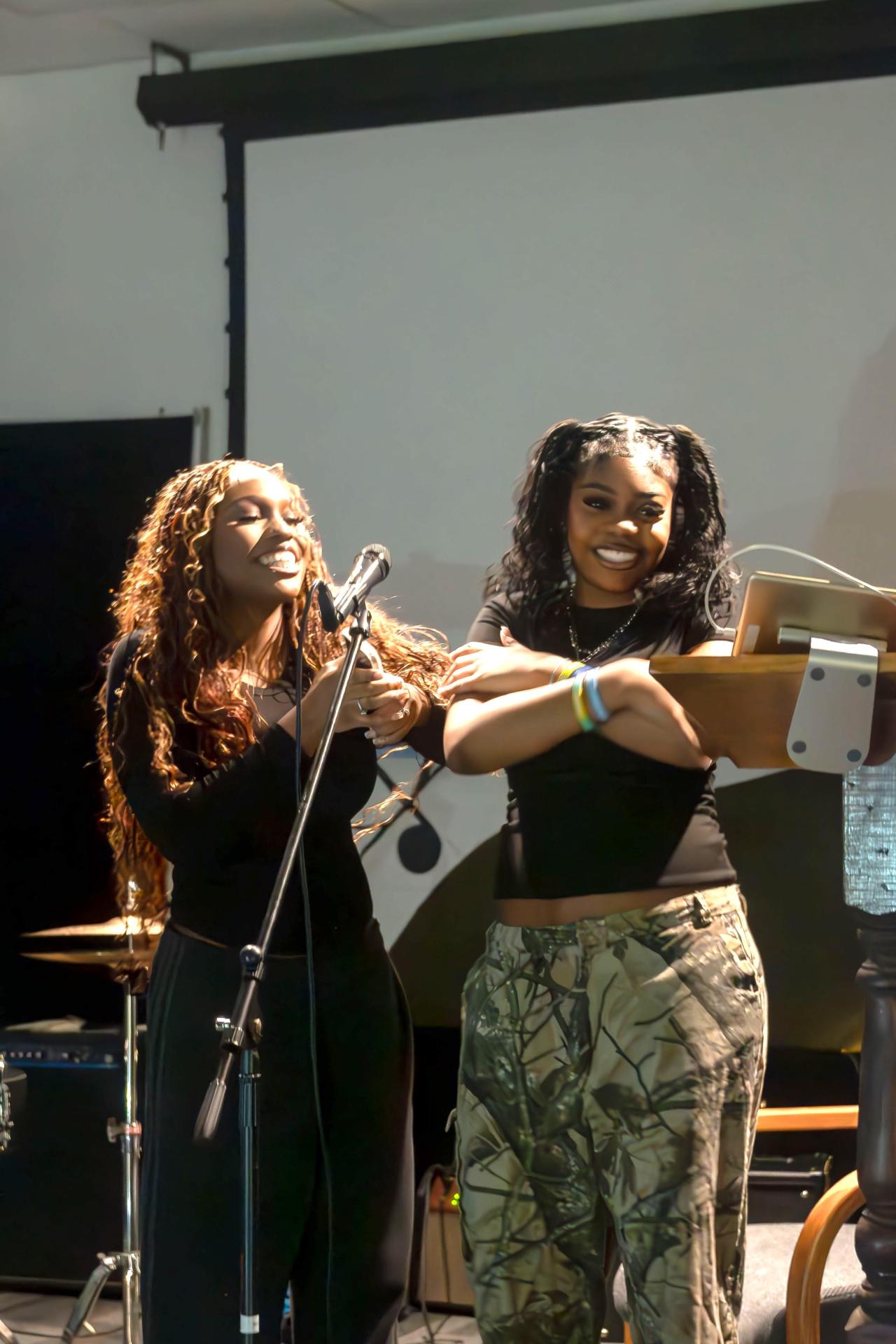 two students singing karaoke in Club 419