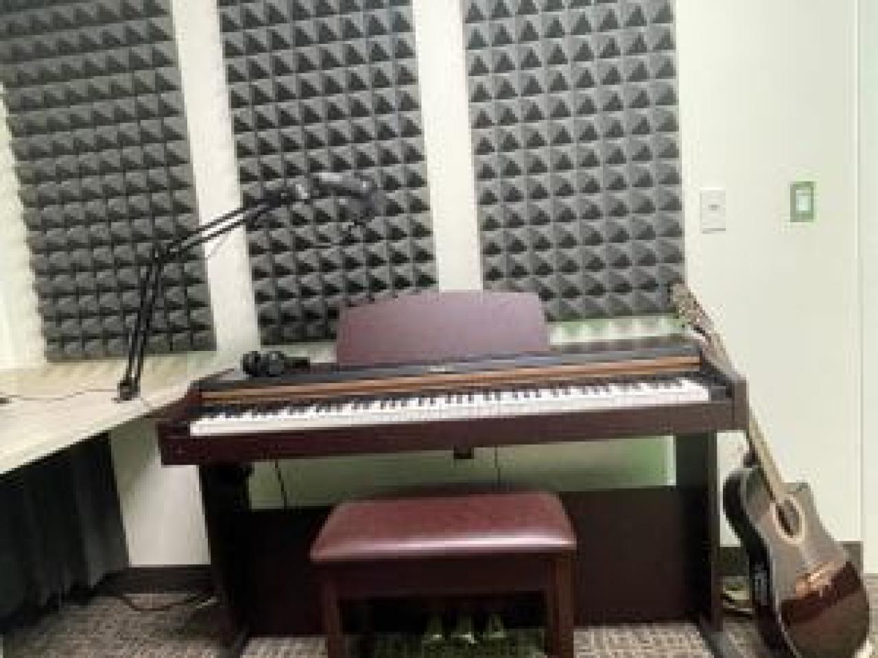 a piano and guitar in a studio setting