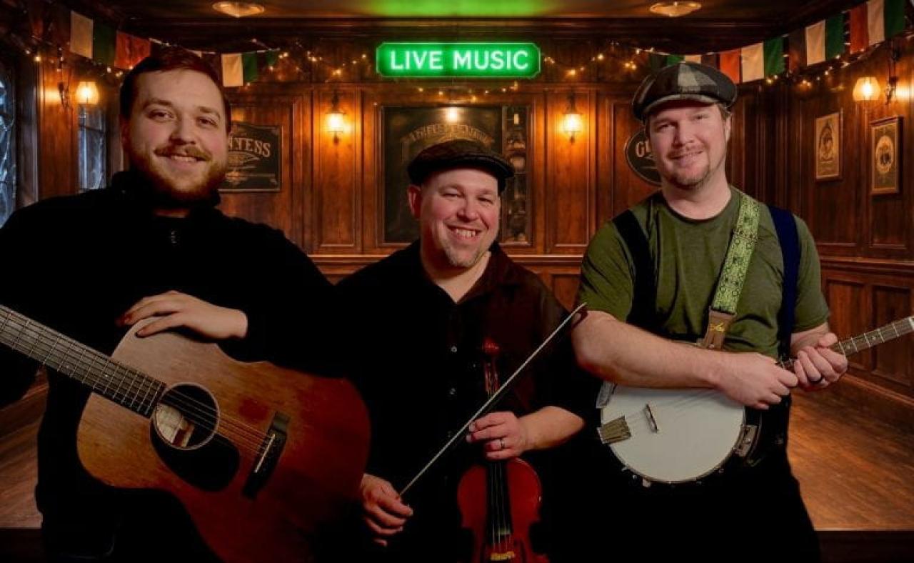 three band members posing with their instruments