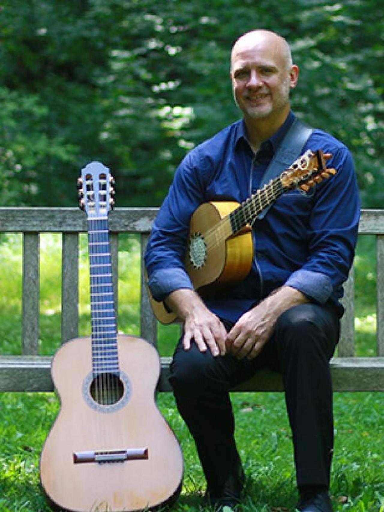 Karl Wohlwend posing with two guitars