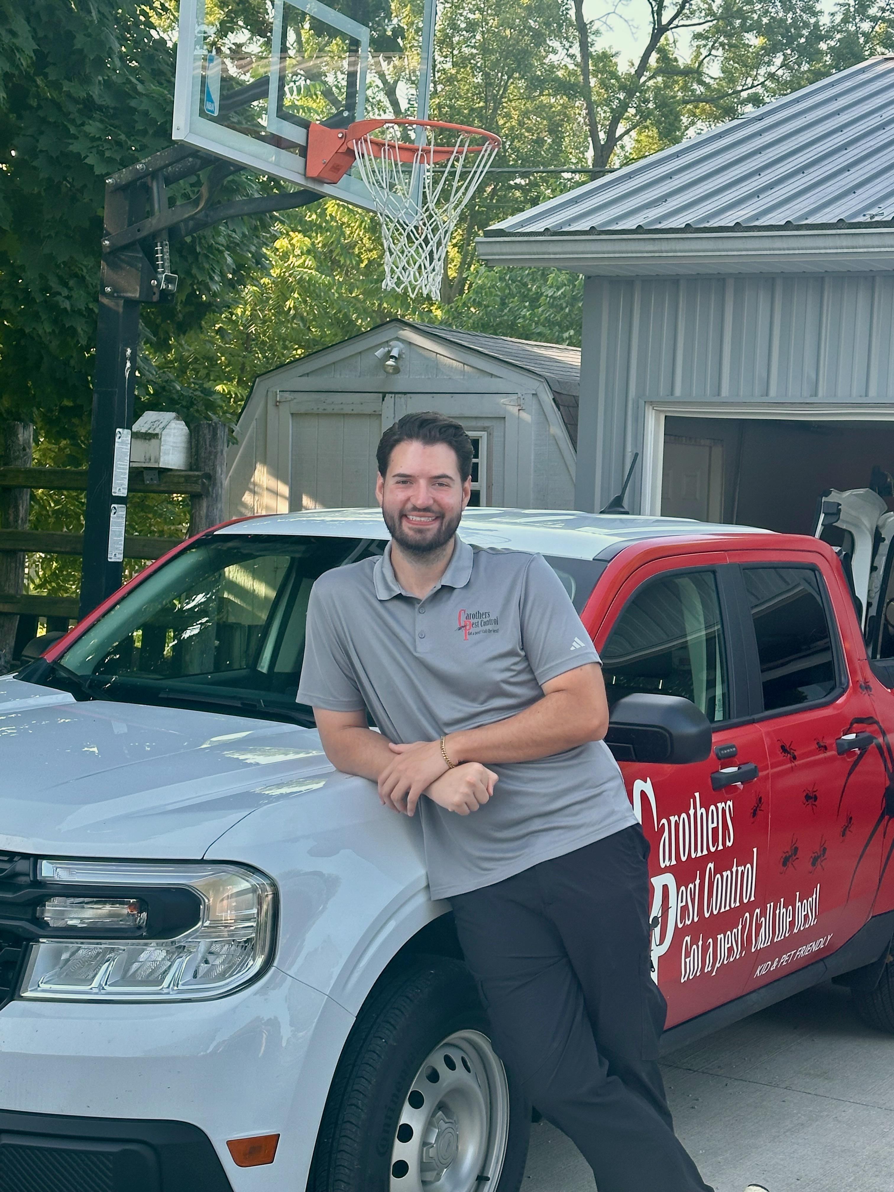 Jack Carothers standing in front of his work truck