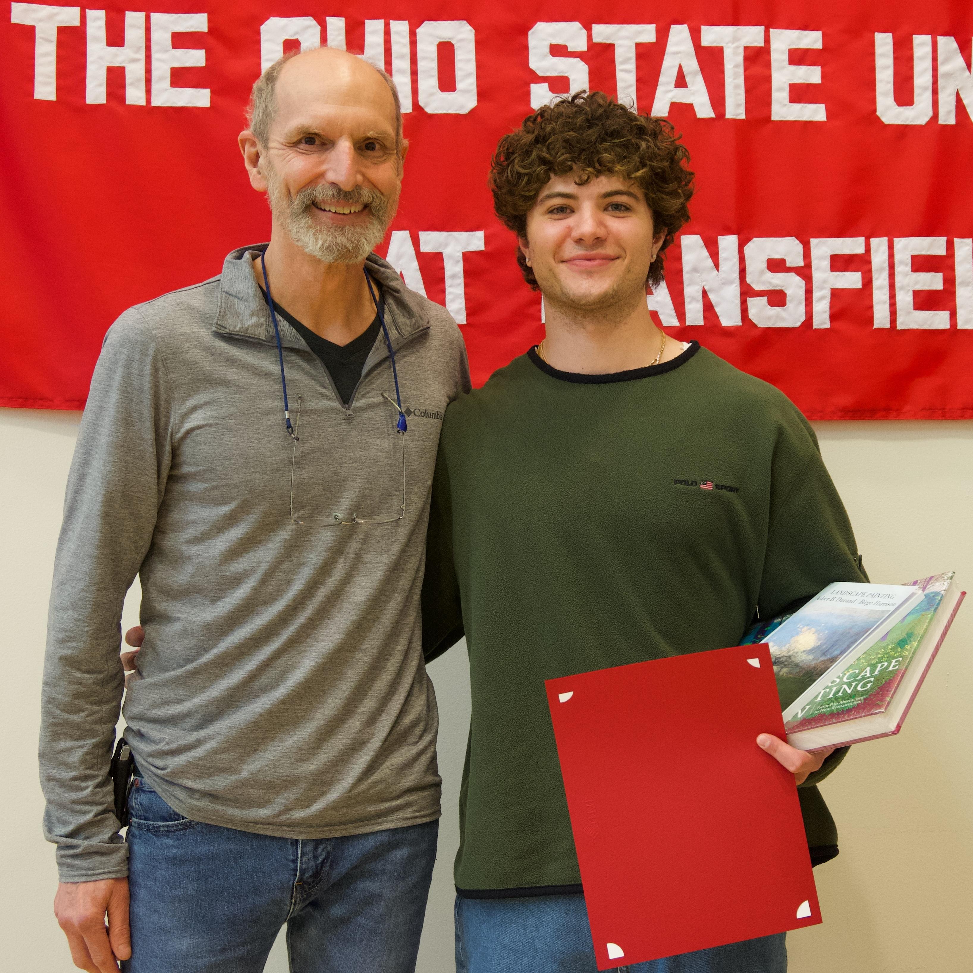 student standing with an adult male