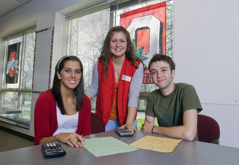 Group of three students studying together