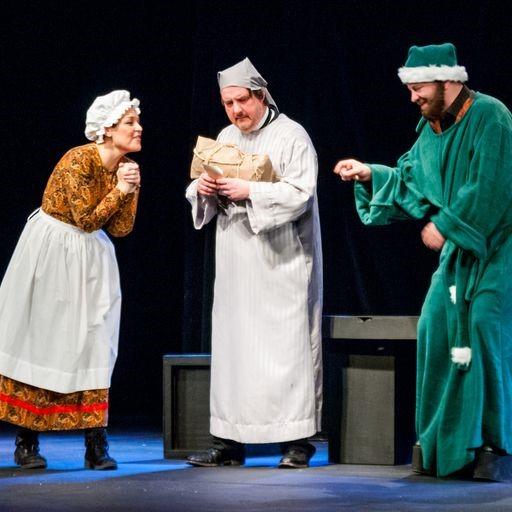 Three characters in full dress on stage