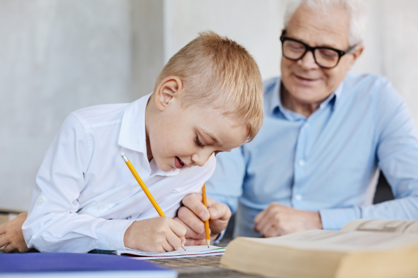 an adult male helping a young child with homework