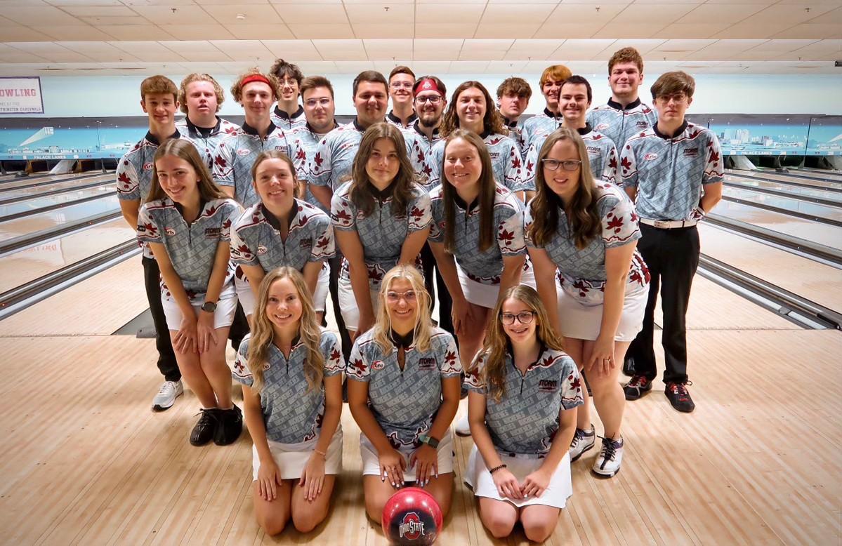 a bowling team with bowling lanes in the background