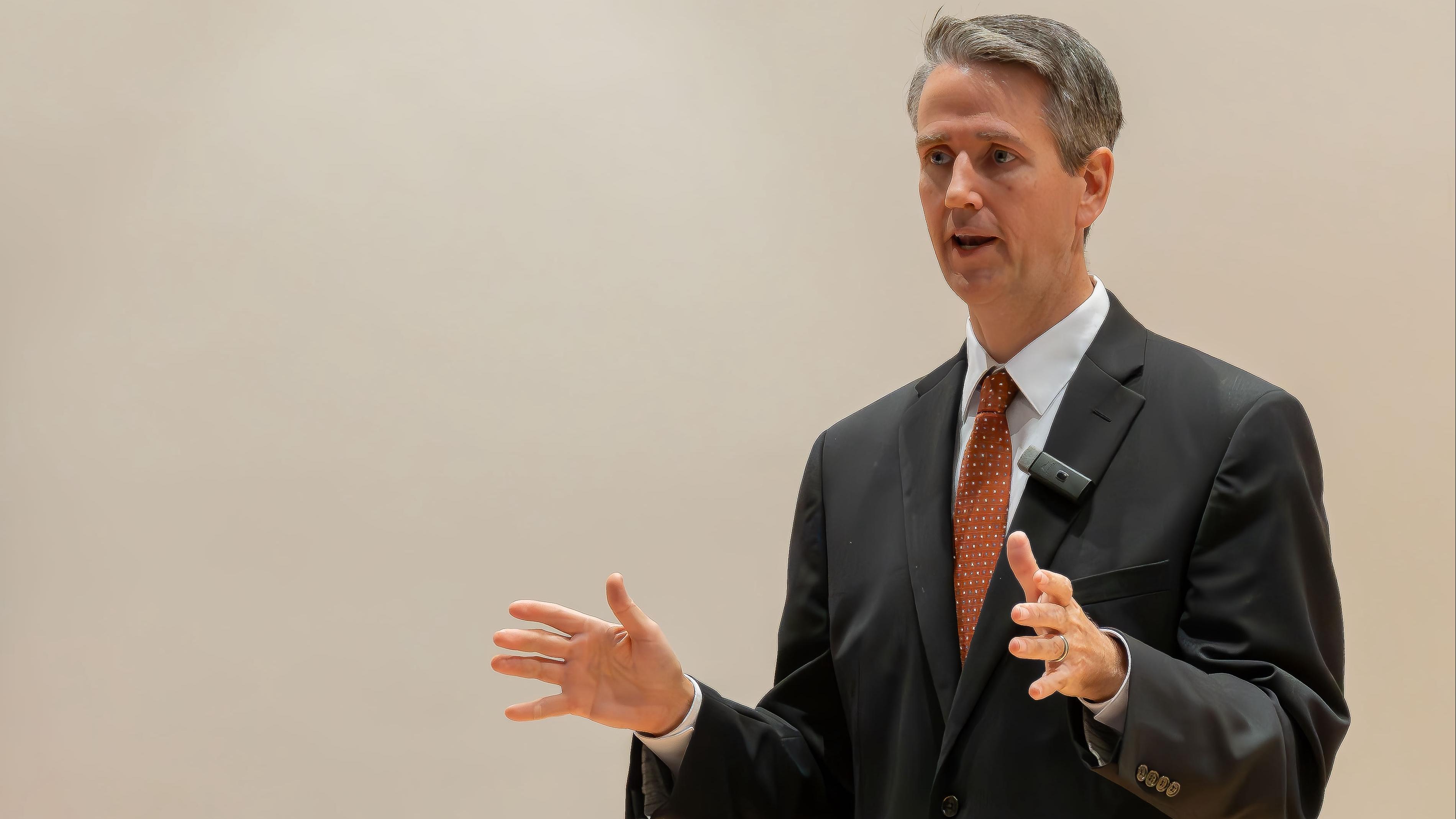 A male speaking in Riedl hall