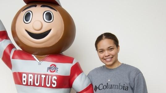 Destiny Moton posing with a statue of Brutus Buckeye