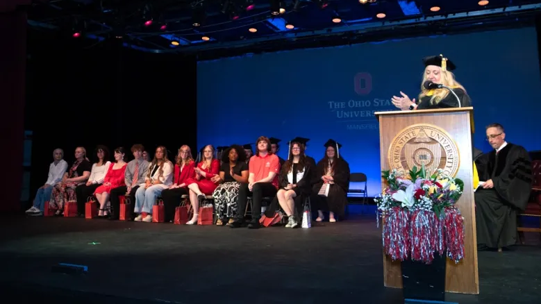 Dawn Kitchen speaking at a graduation celebration