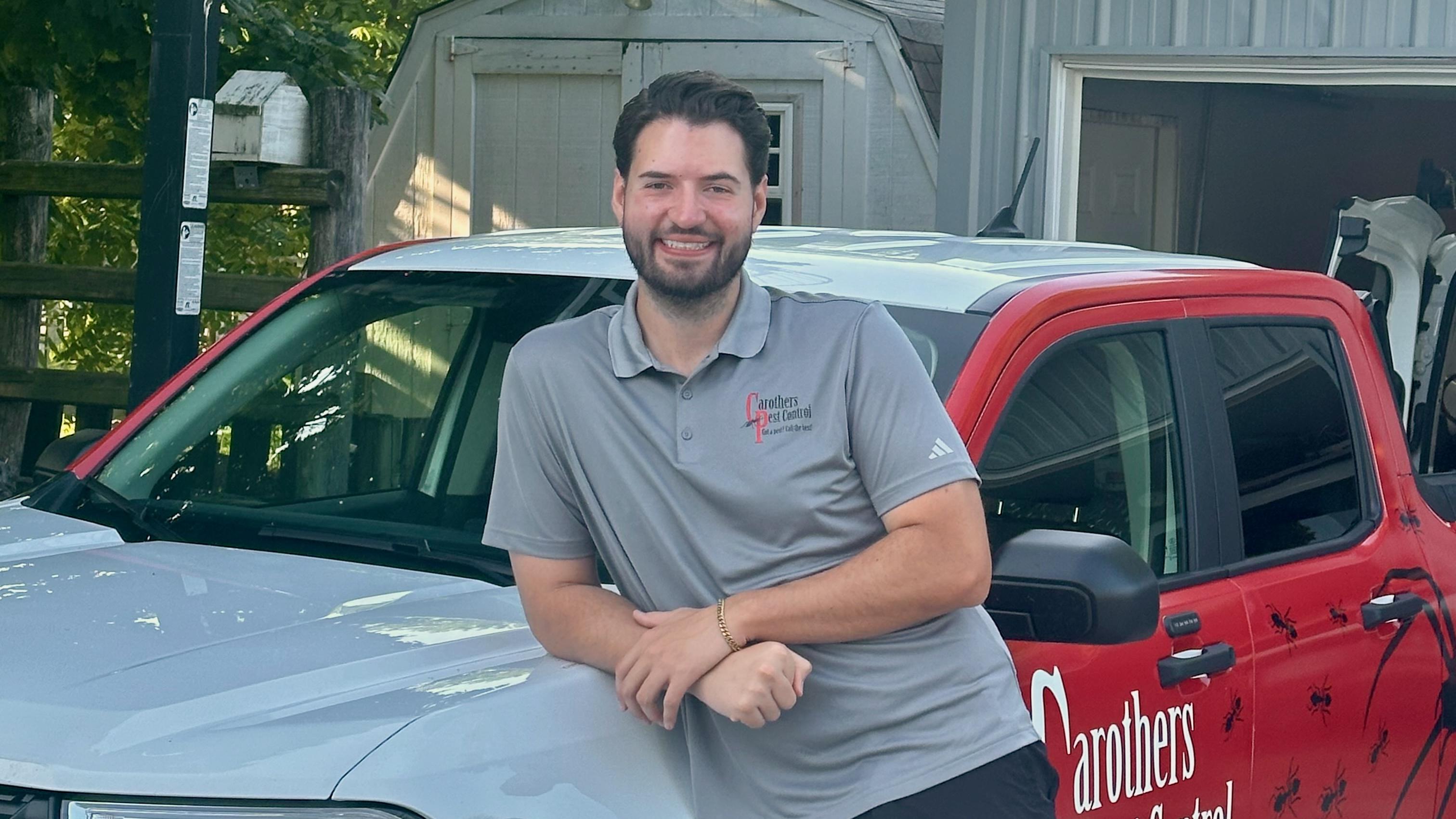 Jack Carothers standing in front of his work truck
