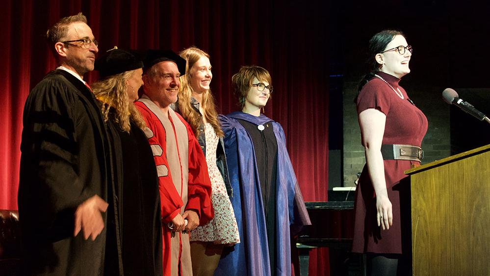 student singing on stage to open the convocation