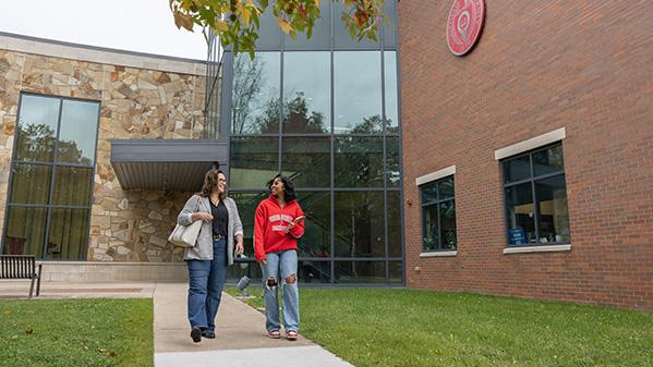 Two students walking outside of a building at Ohio State Mansfield
