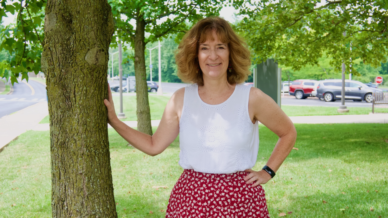 Heather Tanner posing outdoors next to a tree