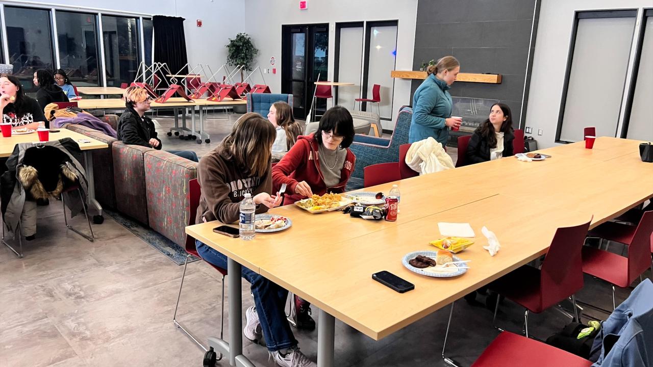 group of people eating and talking 