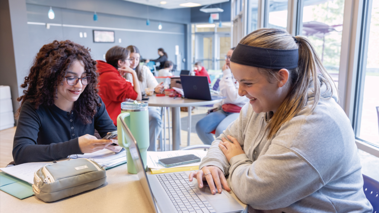 students sitting at a table in a cafe