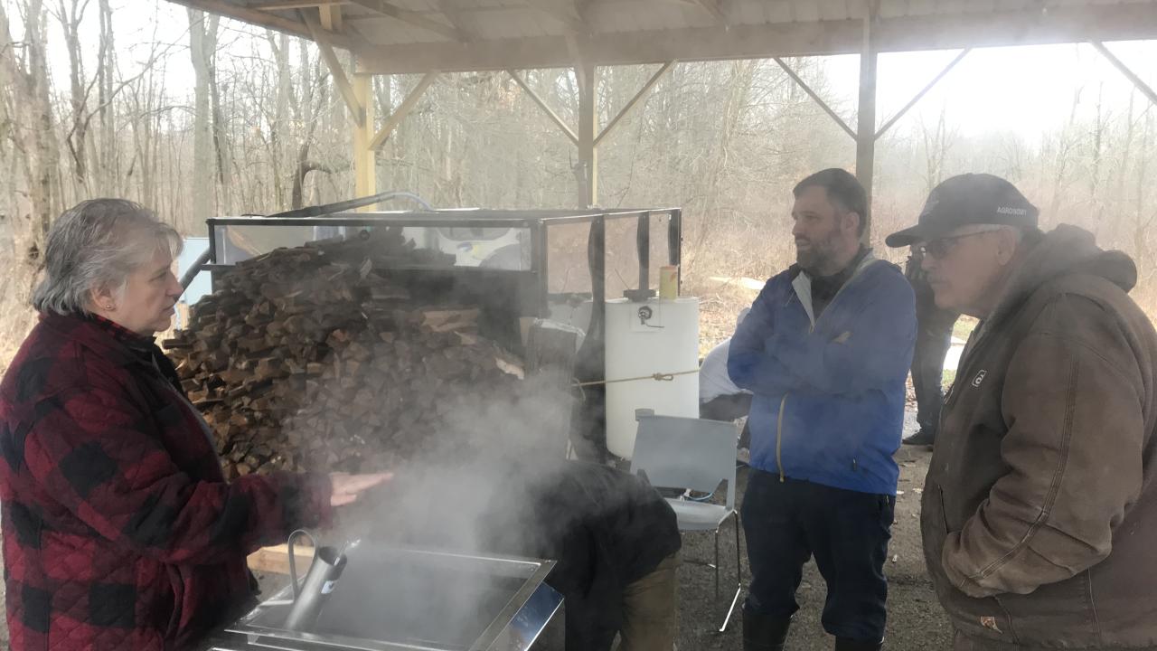 Steam billows off a maple evaporator under a pavilion at the Ohio State Mansfield-campus.