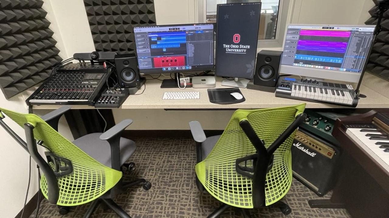 studio set up with mixer boards, keyboards and computer monitors 